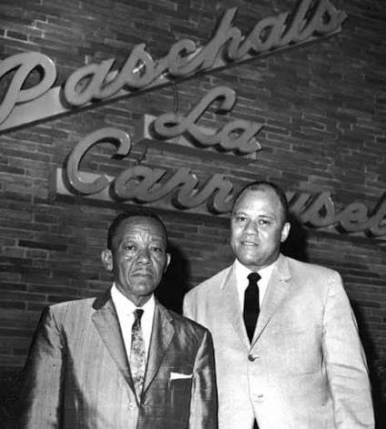 The Paschal brothers beneath the La Carrousel sign